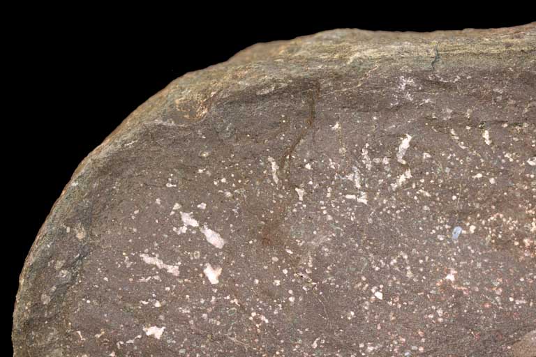 Colour image of brown rock with white spots