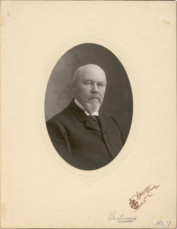 Black and white photograph of a man in a suite in an oval frame