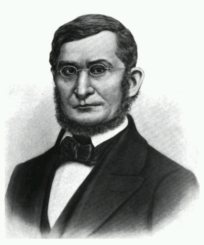 Black and white print of man in black suit, beard and glasses